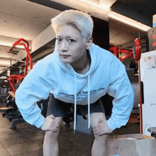 a man wearing a white hoodie that says origin of crispy