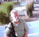 a man with a beard is wearing a striped shirt and carrying a bag