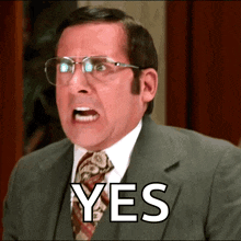 a man in a suit and tie with glasses says yes