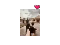 a young man with a heart above his head holds a bag of food in his mouth