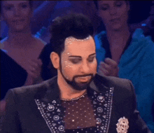 a man with a beard is holding a trophy that says ' winner ' on it