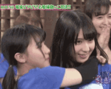 a group of girls are hugging each other and the words round are on the bottom