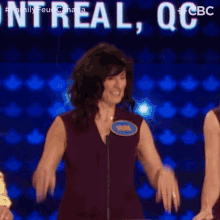 a woman wearing a name tag that says bruna is standing in front of a microphone on a stage .