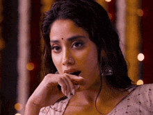 a woman with a nose ring on her nose