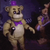 a teddy bear is holding a microphone and wearing a purple bow tie .