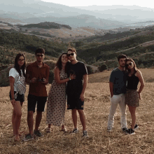 a group of people standing in a field with one wearing shorts that say 00