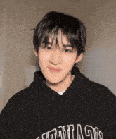 a young man wearing a black sweatshirt with the word chicago on it