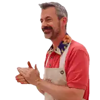 a man wearing a red shirt and an apron that says organic