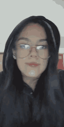 a close up of a woman wearing glasses and a hood