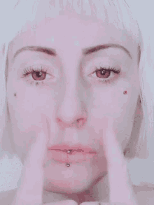 a close up of a woman 's face with white hair