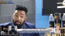 a man with a beard is sitting in front of a screen that says champion