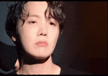 a close up of a person 's face with a shadow on it