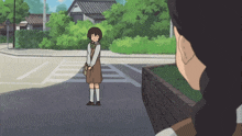 a girl in a brown dress and white socks is standing on the street