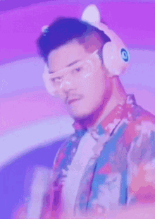 a man wearing headphones and glasses is holding a toy gun