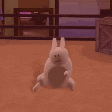 a white rabbit is standing on its hind legs in a room with a fence in the background .