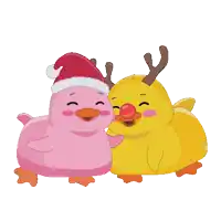 a pink duck is wearing a santa hat and a yellow duck with antlers is wearing a red nose
