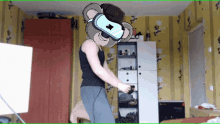 a cartoon koala wearing a virtual reality headset is dancing in a bedroom