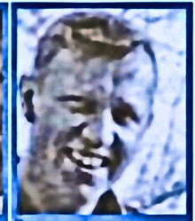 a close up of a man 's face with a blue border