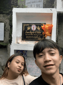 a man and a woman are posing in front of a plaque that says zane angels & colin