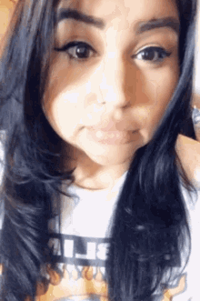 a close up of a woman 's face with a t-shirt that says " believe "