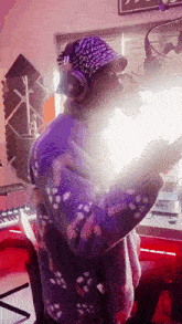 a man wearing a bandana and headphones singing into a microphone