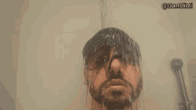 a man with a beard is taking a shower with the hashtag @t3amolioti