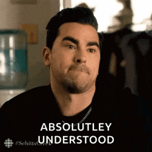 a man with a beard is making a funny face and saying `` absolutely understood '' .