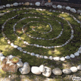 a picture of a spiral made of rocks and moss with pixiz written on the bottom