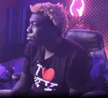 a man wearing a black shirt that says i love ny on it