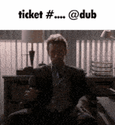 a man in a suit is sitting in front of a sign that says ticket #
