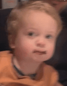 a blurry picture of a young boy making a face