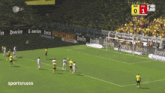 a soccer game is being played on a field with ads for bwin on the sidelines