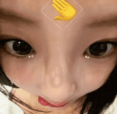a close up of a woman 's face with a hand emoji on her forehead