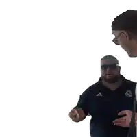 a man wearing a black adidas shirt talks to another man wearing sunglasses