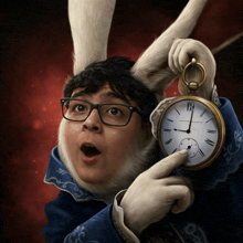 a boy with glasses and rabbit ears is holding a pocket watch with roman numerals on it