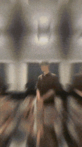 a blurry picture of a person walking in a dark room