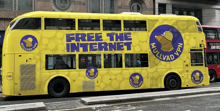 a yellow double decker bus that says free the internet on the side
