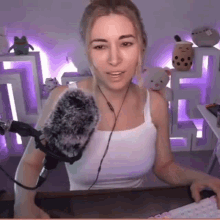 a woman is sitting in front of a microphone in a room .