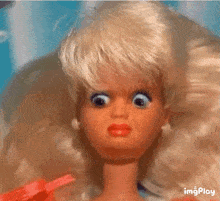 a close up of a barbie doll with a surprised look on her face ..