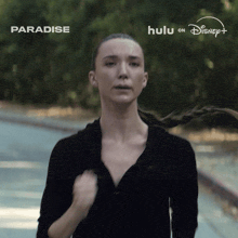a woman is running on a road with the words paradise behind her