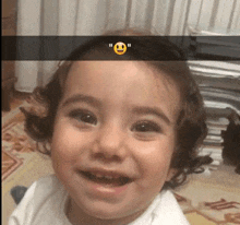 a little girl with a smiley face on her forehead