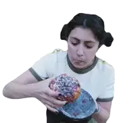 a woman in a white shirt is holding a donut