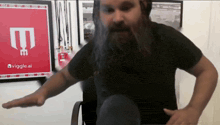 a man with a beard is standing in front of a sign that says ' viggles ai '