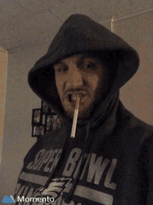 a man with a cigarette in his mouth wears a super bowl shirt