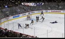 a hockey game is being played in a stadium and the score is 2 to 1
