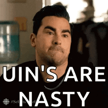 a man is making a funny face with the words `` uin 's are nasty '' .