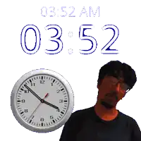 a man stands in front of a clock that says 03.52 am