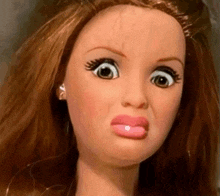 a close up of a barbie doll with a funny face