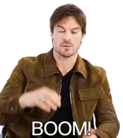 a man in a brown jacket says boom with his eyes closed
