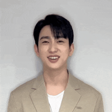 a close up of a man 's face with a tan jacket on